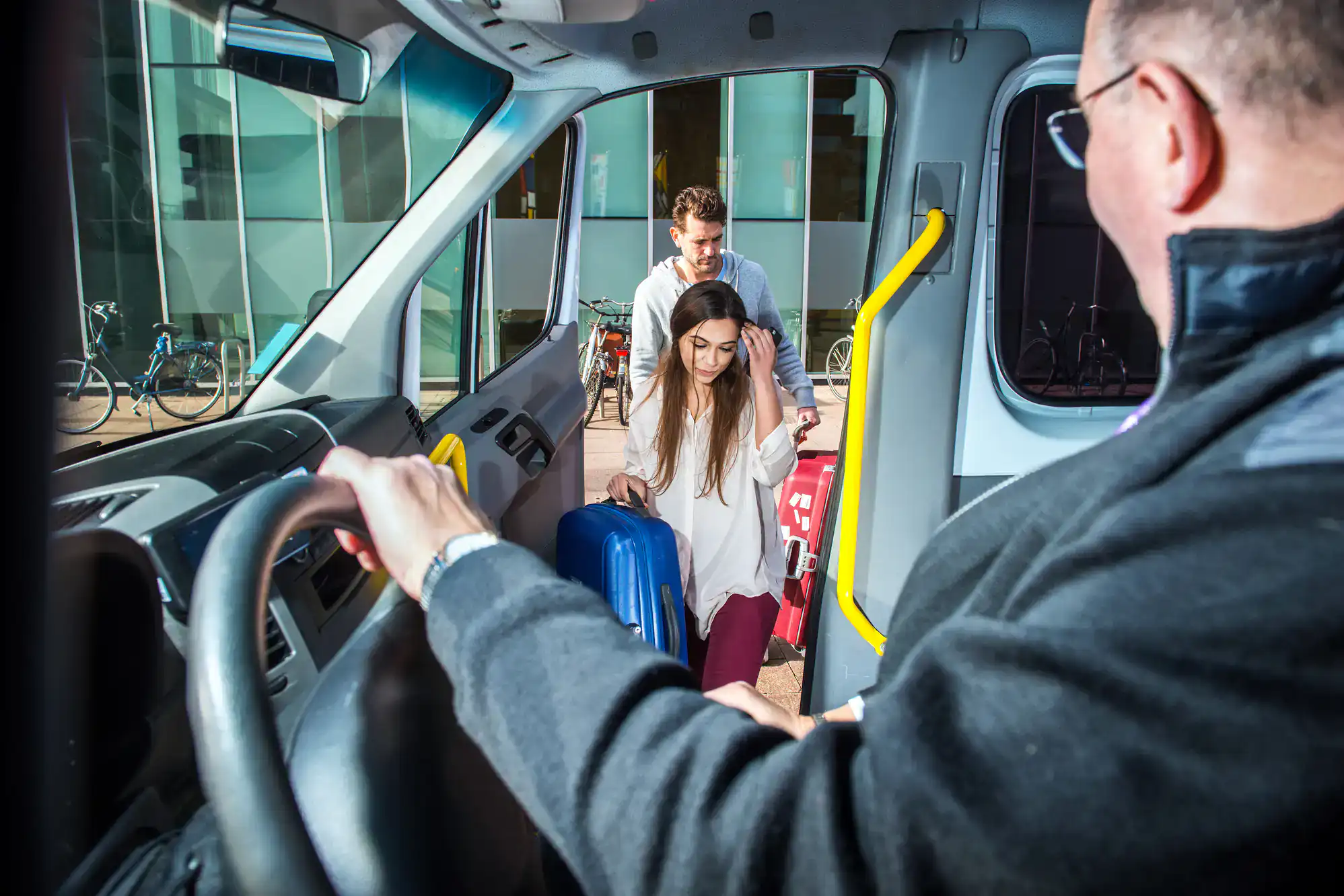 Passengers with luggage boarding a Philadelphia airport shuttle, preparing for travel in Philadelphia County, PA, highlighting the convenience and comfort of Philadelphia Car and Limo services