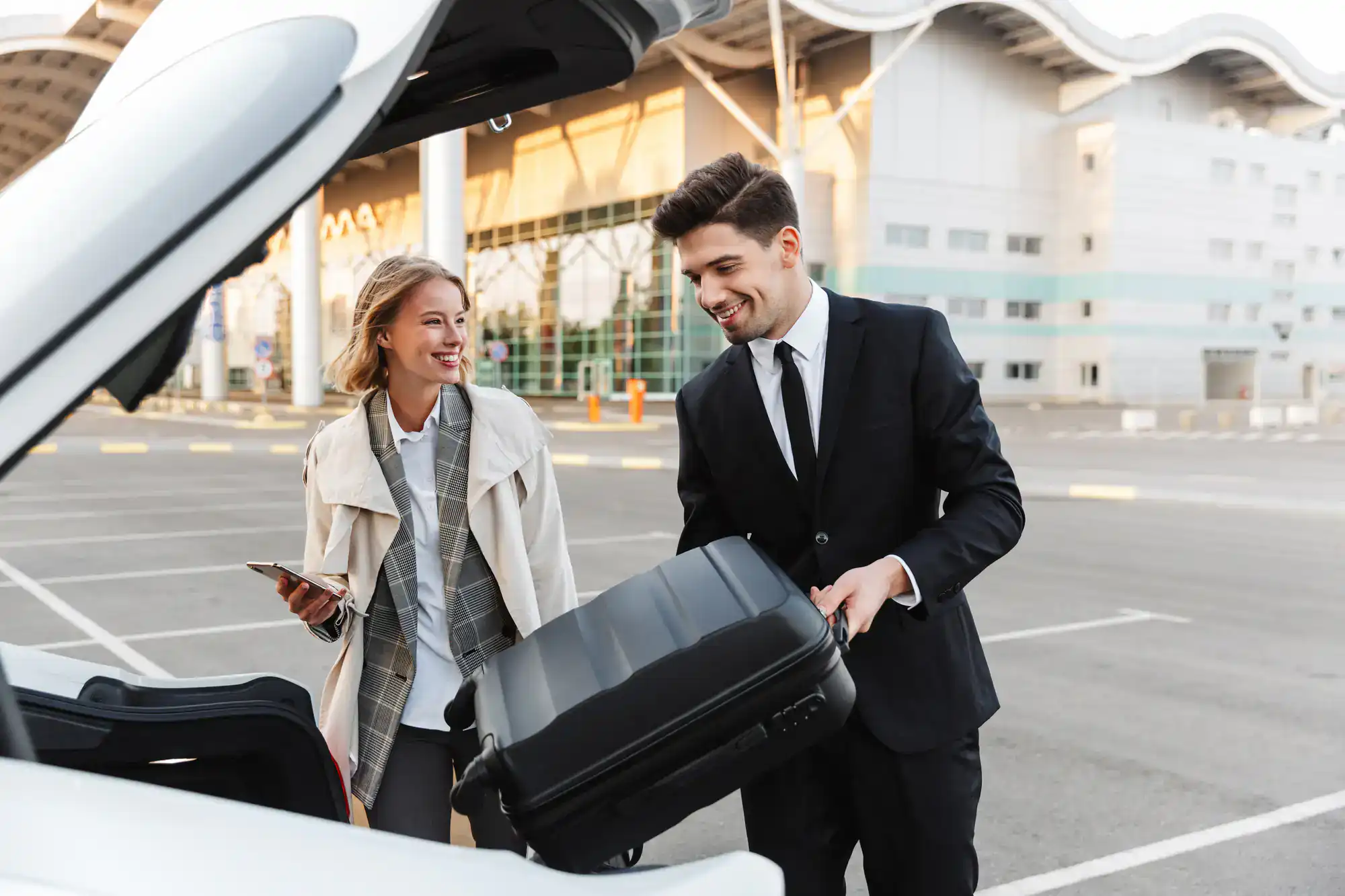 A professional chauffeur-assisted luxury car arrives at Philadelphia International Airport, ready to transport business travelers promptly and comfortably throughout Philadelphia County, PA