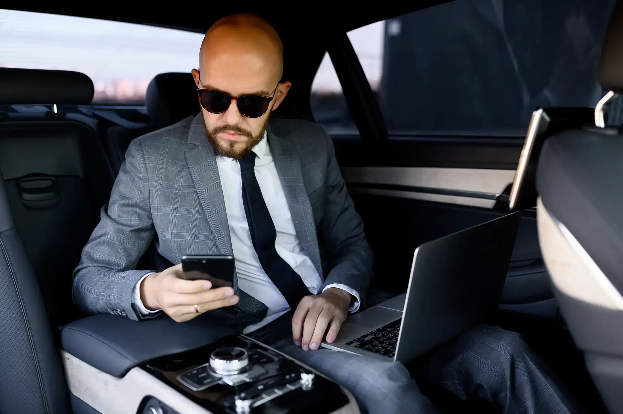 Businessman dressed in a suit exiting a high-end limousine in Philadelphia County, PA, ready for a meeting or event, highlighting Philadelphia Car and Limo’s reliable corporate transport