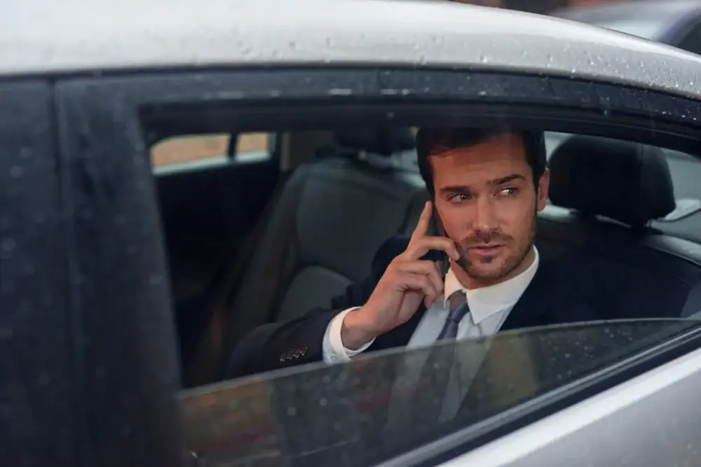 A businessman in Philadelphia County, PA, on a call, representing the reliability and professionalism of Philadelphia Car and Limo