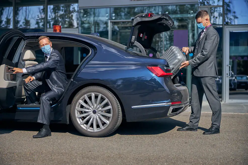 A professional businessman in a mask enjoys a smooth ride through Philadelphia County, Pennsylvania, with Philadelphia Car and Limo