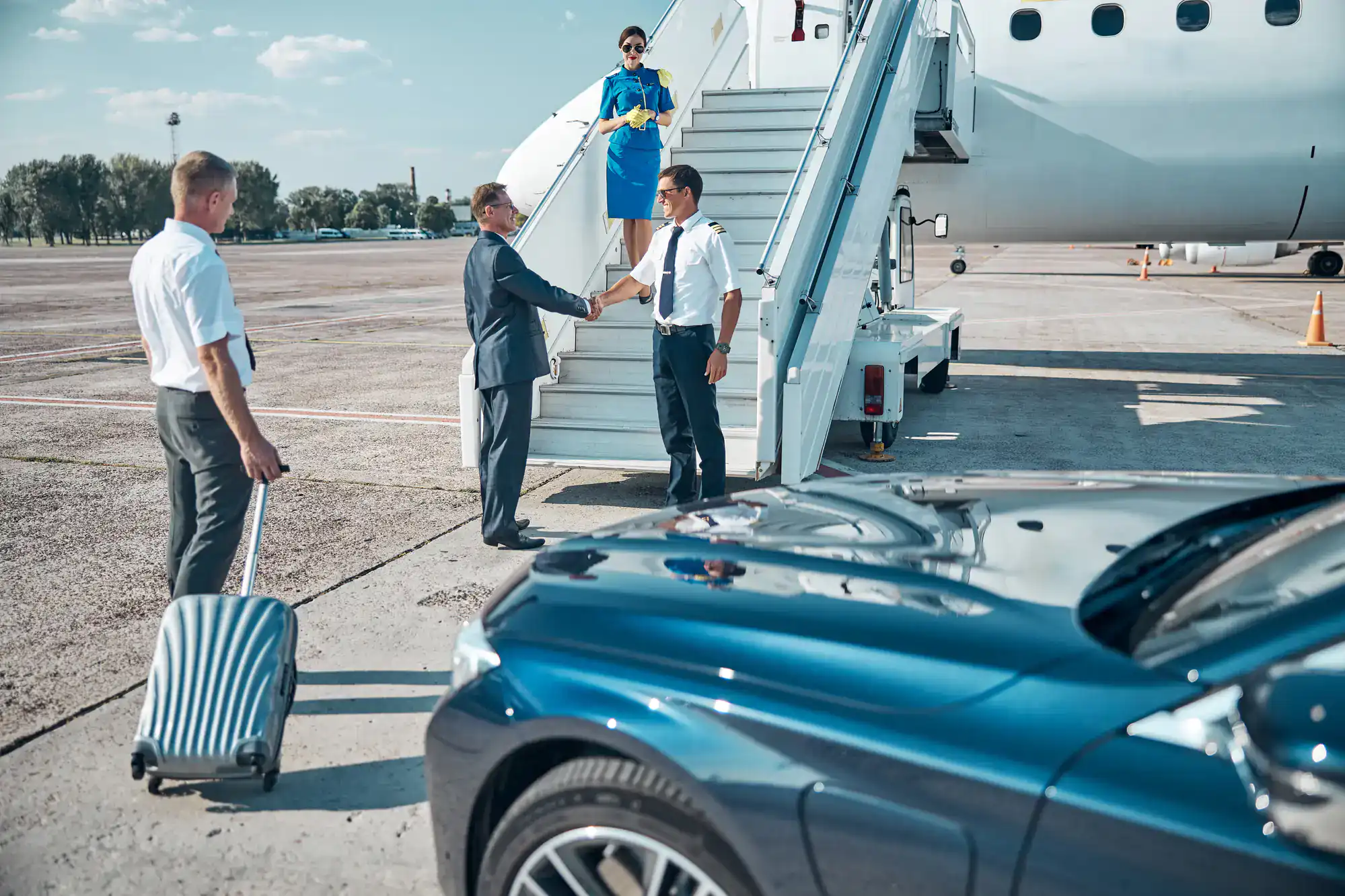 Chauffeur warmly greeting passengers as they arrive at a private jet in Philadelphia County, PA, offering premium car and limo services with professionalism and luxury