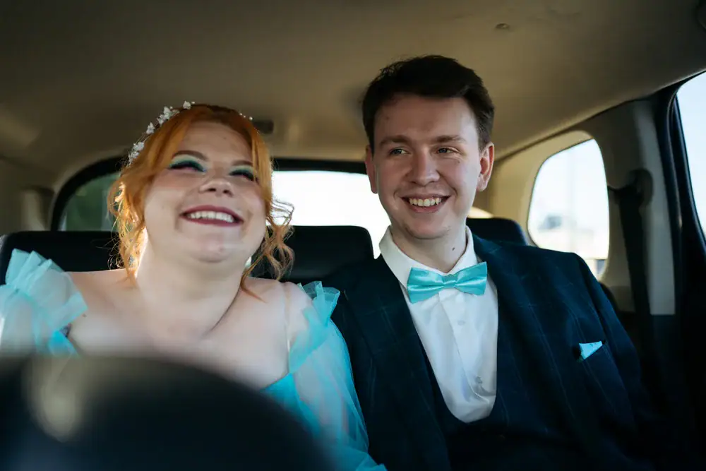 A joyful couple enjoying a luxurious ride in a sleek car, celebrating their special day in Philadelphia County, Pennsylvania with Philadelphia Car and Limo