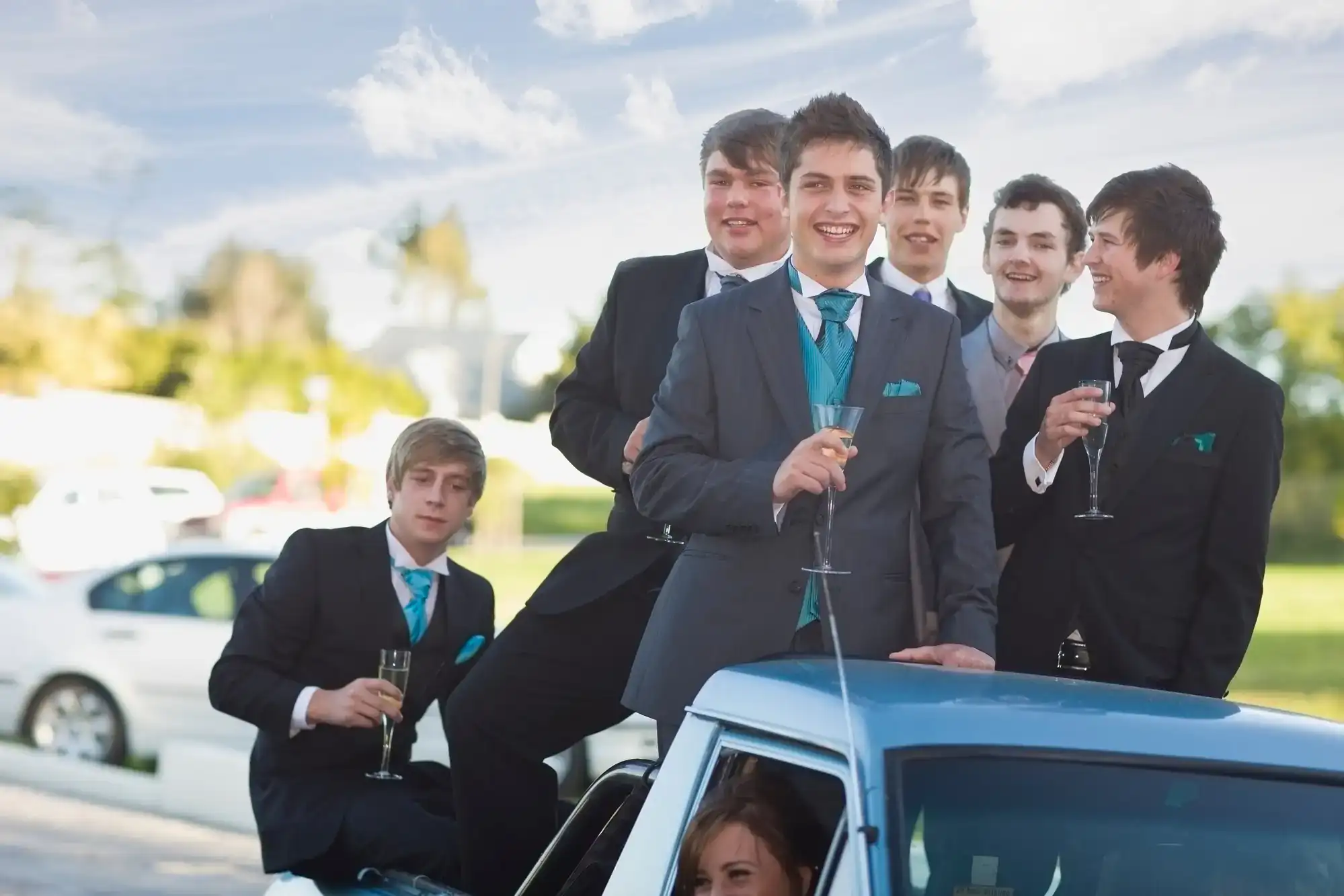 Group of prom boys dressed in formal attire stepping into a sleek limousine for their celebration in Philadelphia County, PA, capturing the excitement and elegance of the special occasion
