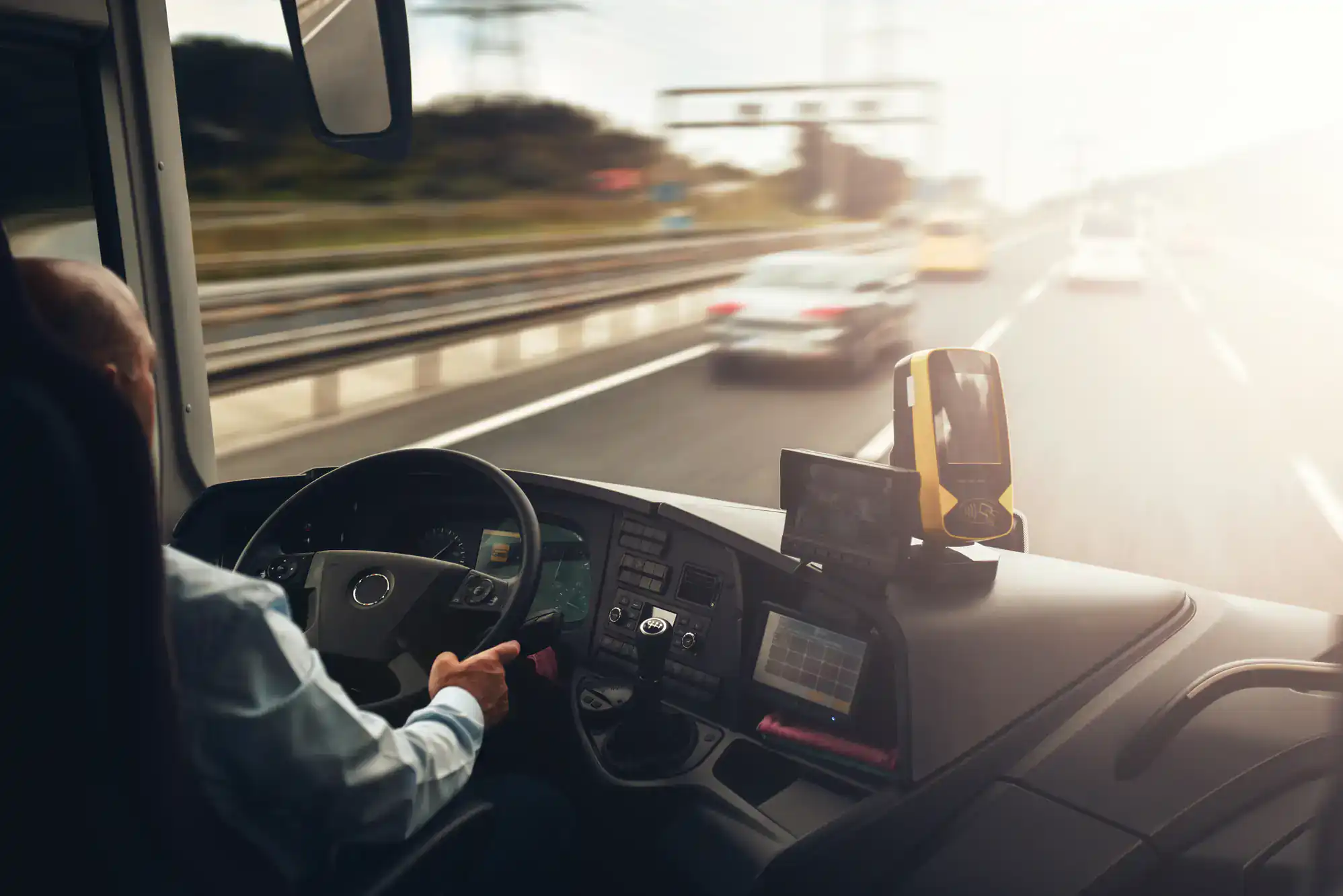 Shuttle bus traveling on a highway in Philadelphia County, PA, representing safe and comfortable transportation services offered by Philadelphia Car and Limo