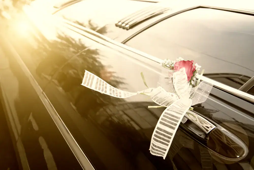 Beautifully adorned wedding limo in Philadelphia County, PA, showcasing delicate flowers, white ribbons, and personalized touches for an unforgettable wedding experience with Philadelphia Car and Limo